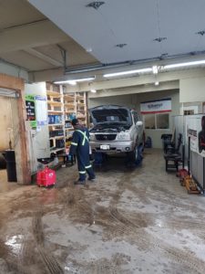 Overview of inside the shop - Car Lift with Worker